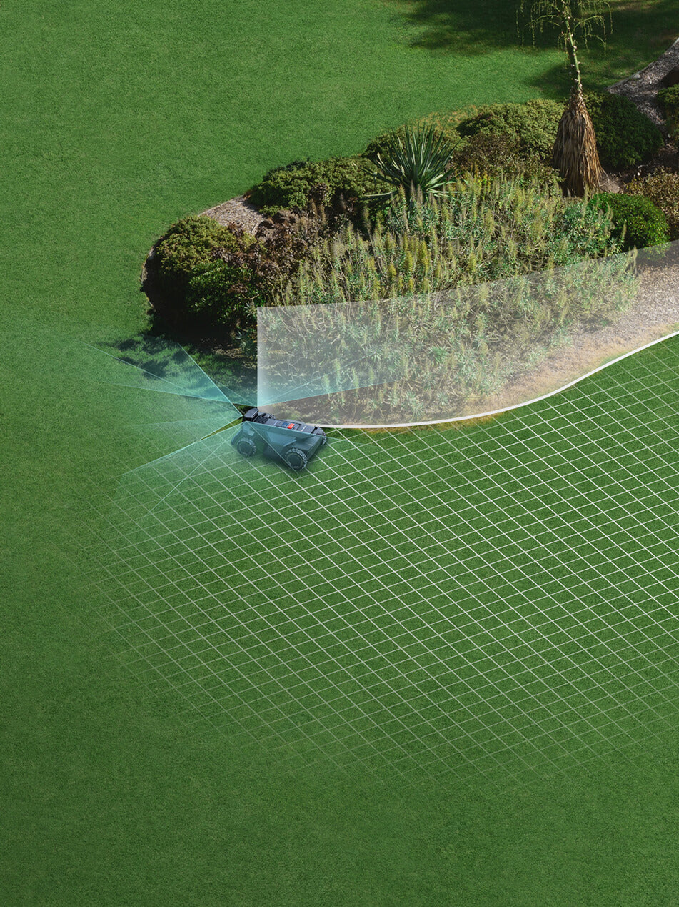 Navimow i110E robot lawn mower mows the green garden grass.