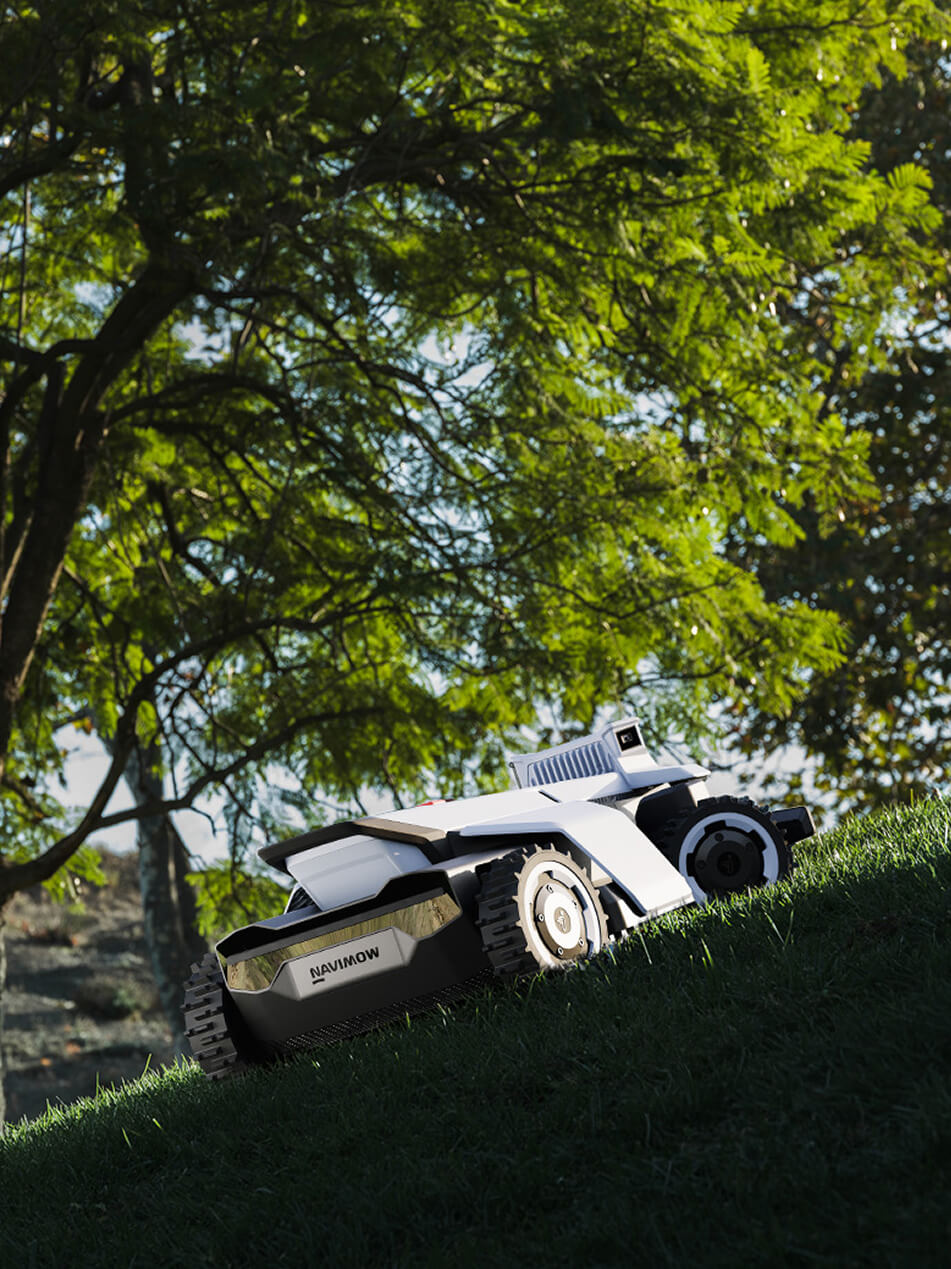 Navimow i110N robot lawn mower is climbing a grassy hill.