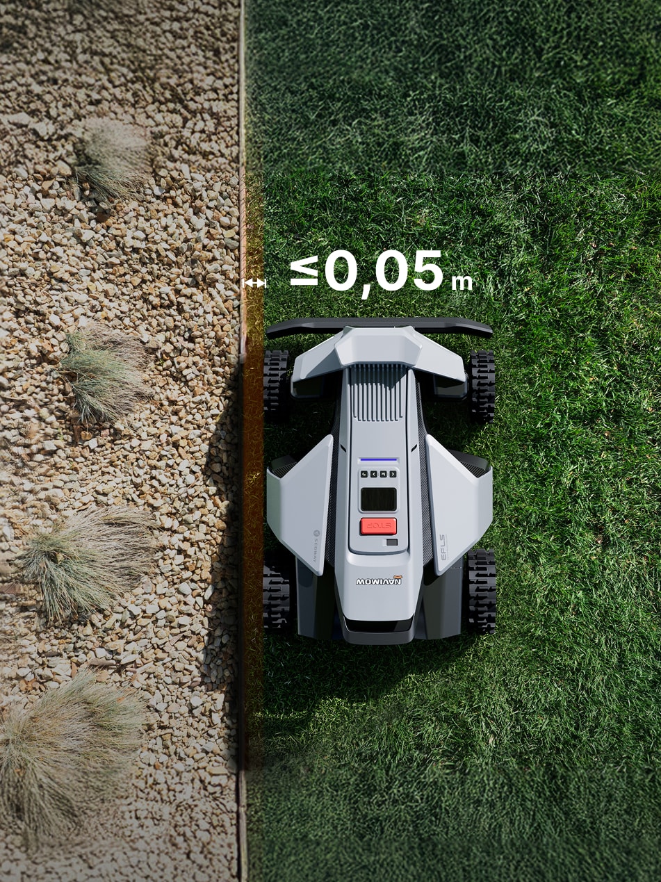 Navimow i105 robot lawn mower trims grass near pebble border.